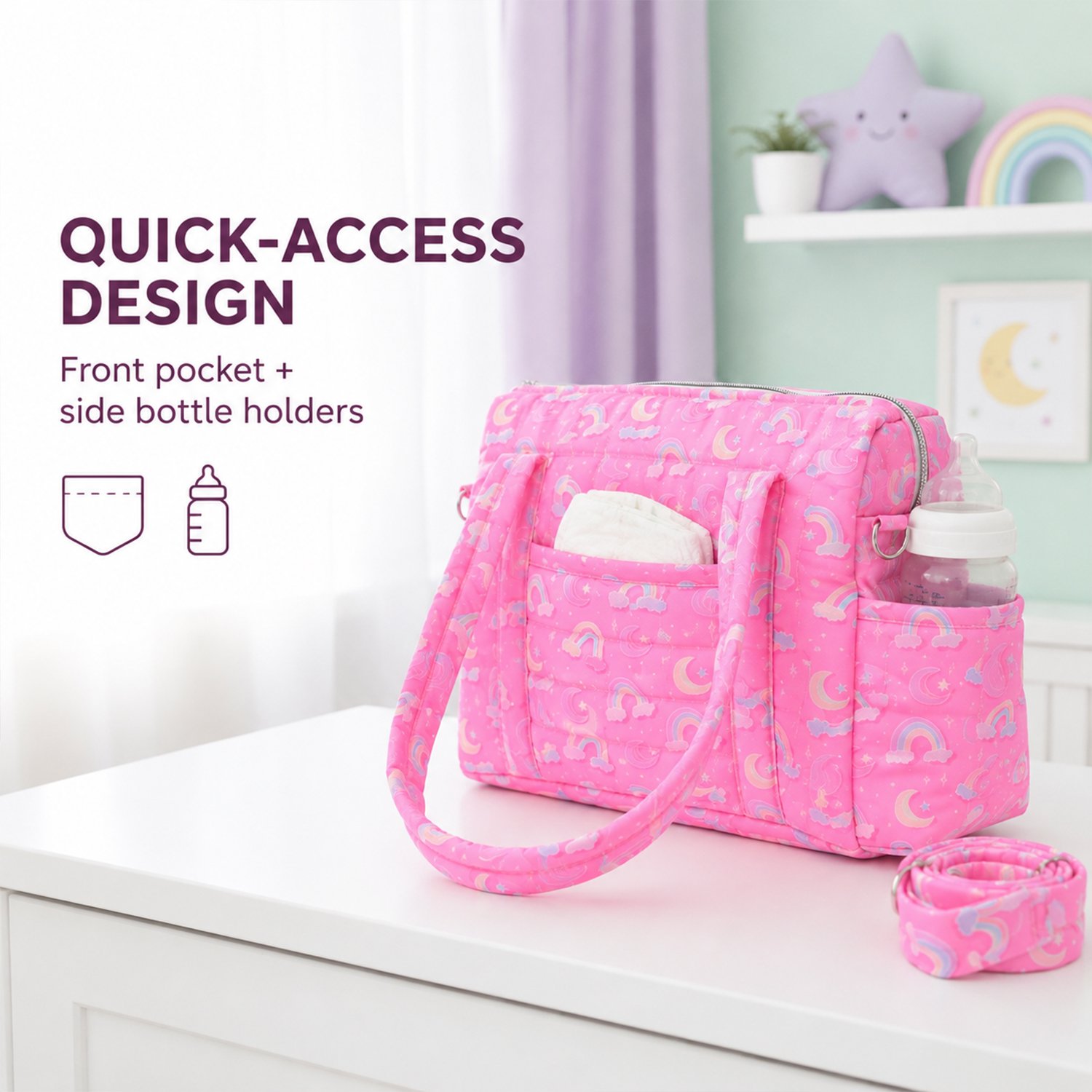 Pink diaper bag with rainbows on a white table; text reads 'QUICK-ACCESS DESIGN' and 'Front pocket + side bottle holders' (informational product image).