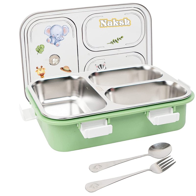 Kids lunchbox with a green base and three-section metal tray, plus a stainless spoon and fork set. Lid features animal stickers and a 'Naksh' label.