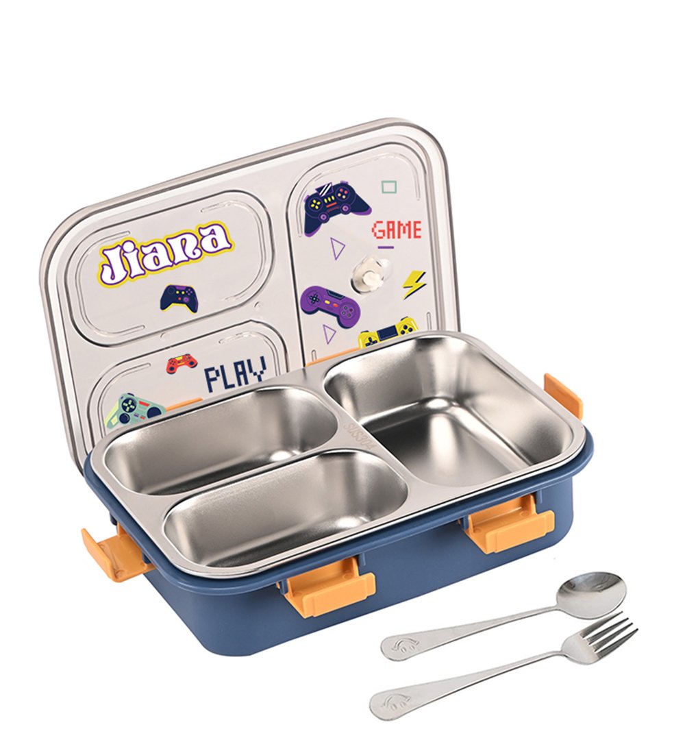 Kids’ blue lunchbox with three stainless-steel compartments, orange latches, and a game-themed lid, shown open with a spoon and fork beside it