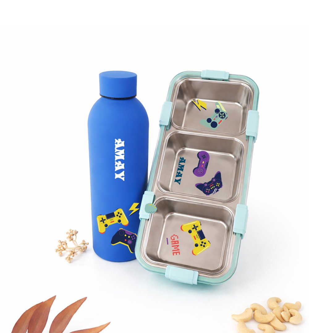 Blue insulated water bottle beside a turquoise, three-compartment lunchbox with gaming stickers and clips on the sides.