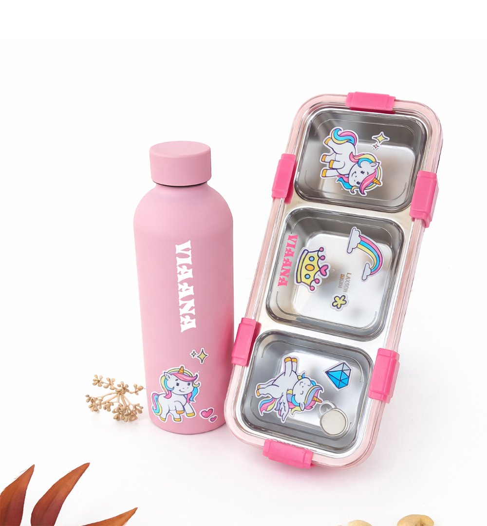 Pink stainless water bottle with a unicorn sticker beside a pink, three-compartment lunchbox with unicorn decals on a white background.