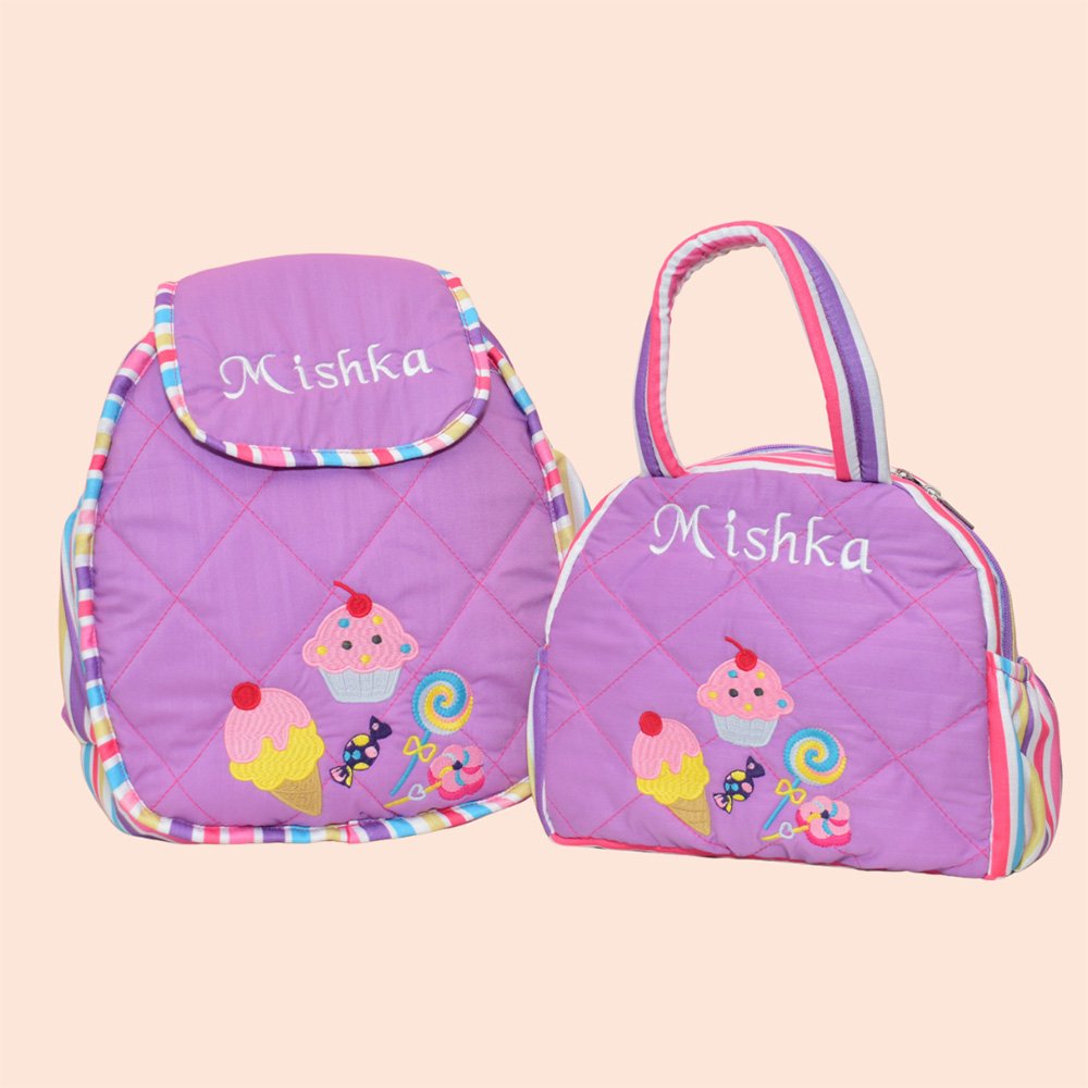Two purple kids' backpacks with colorful candy-ice-cream designs and an embroidered name 'Mishka' on each bag.
