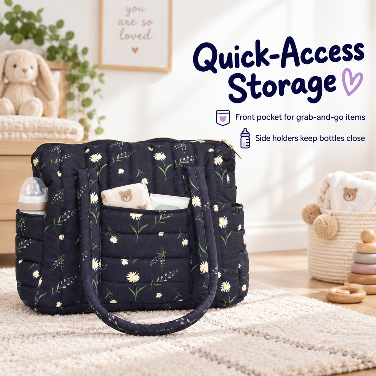 Navy floral quilted diaper bag with pockets on a light rug, with a 'Quick-Access Storage' backdrop featuring a poster and stuffed bunny in the background.