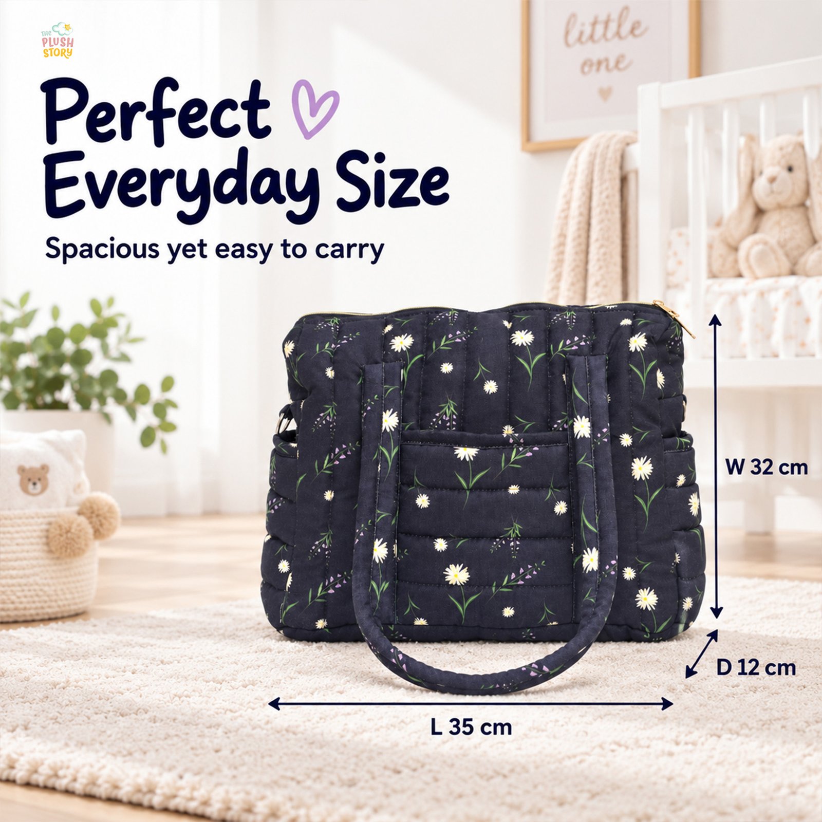 Navy quilted diaper bag with white daisies on display in a nursery, with dimensions: L 35 cm, W 32 cm, D 12 cm.