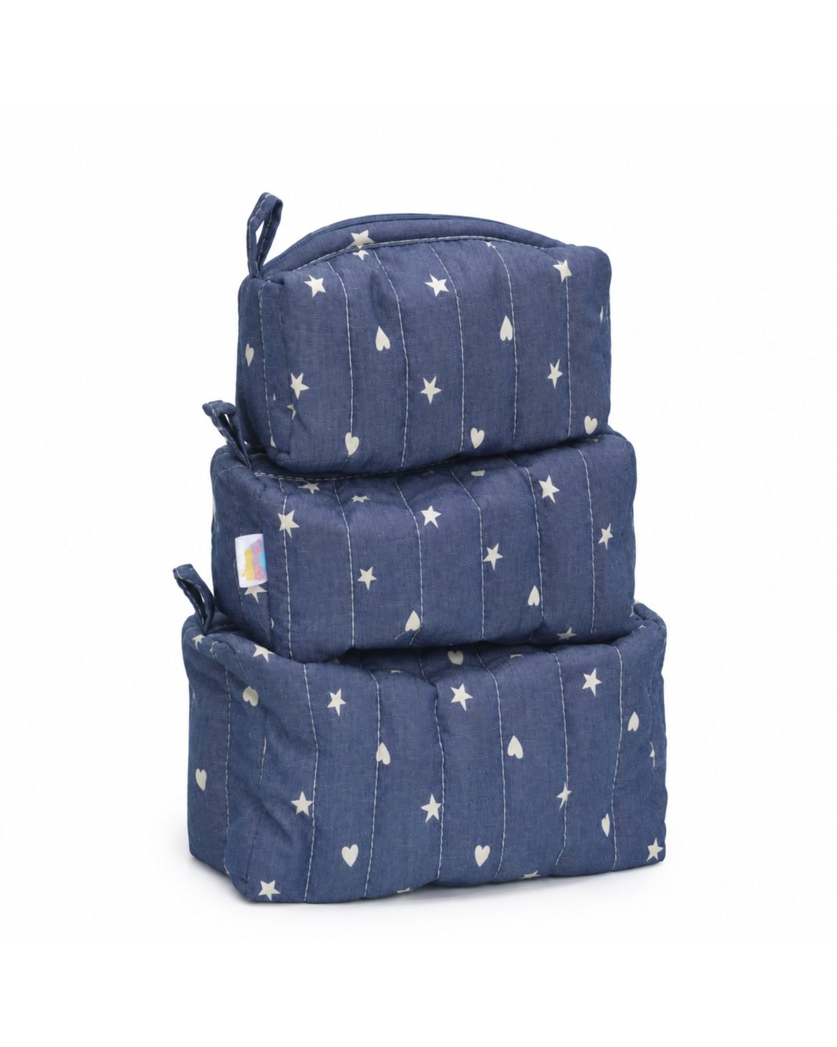 Stack of blue quilted bags with white stars and heart patterns.